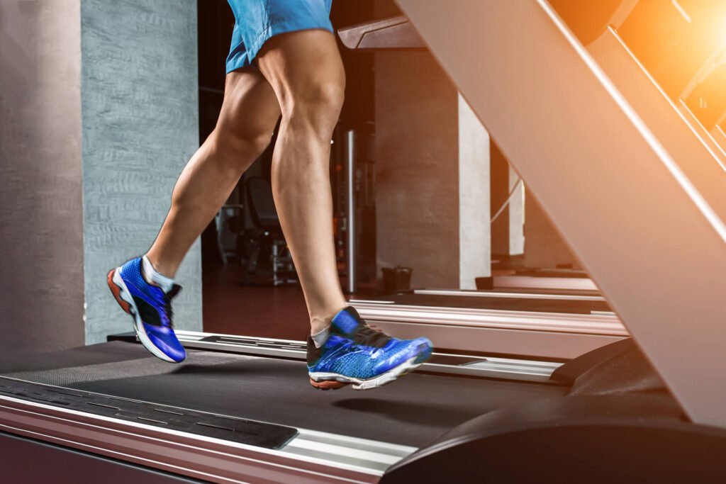 Man running on treadmill at gym